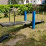 Balancín de madera en un parque infantil vacío, con los dos asientos a distinta altura