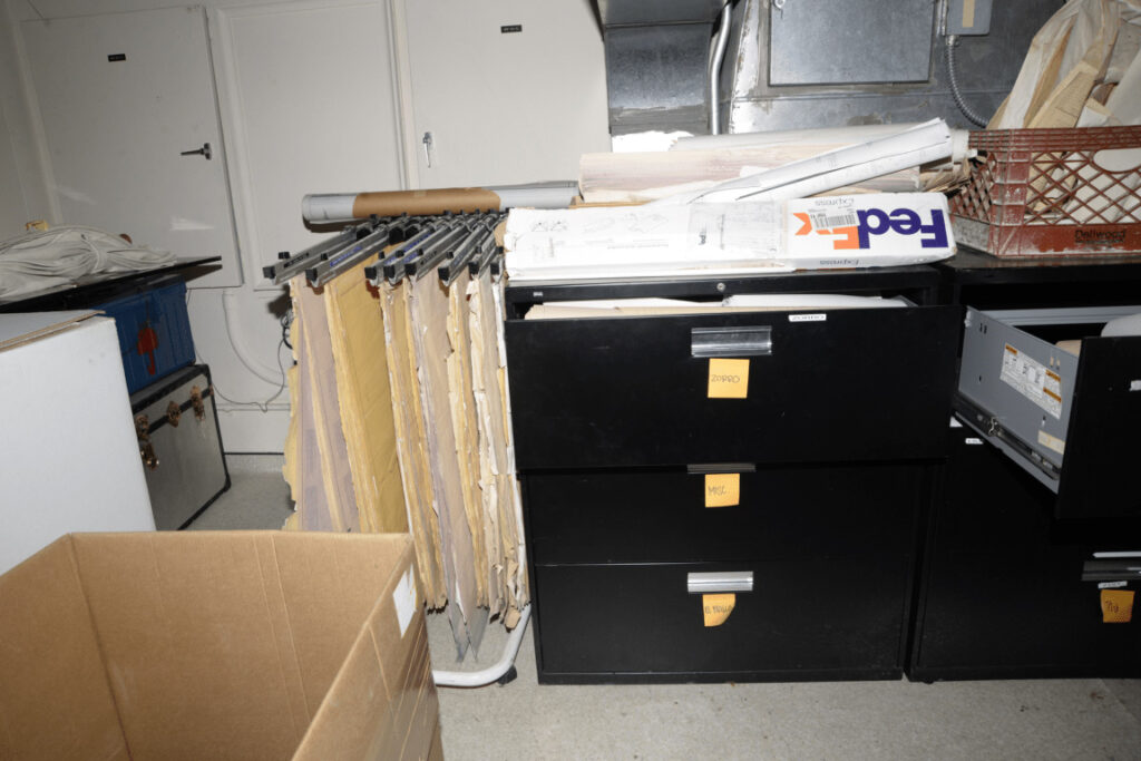 Carpetas de archivo con etiquetas colocadas en vertical dentro de un caj&oacute;n abierto